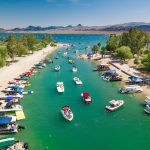 A vibrant marina with boats docked along a narrow waterway.
